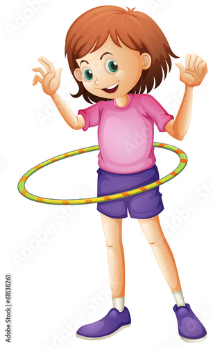 A young girl playing hulahoop