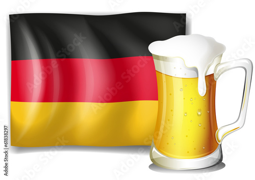 A big mug with cold beer in front of the German flag