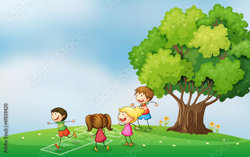 Kids playing at the hilltop near the tree