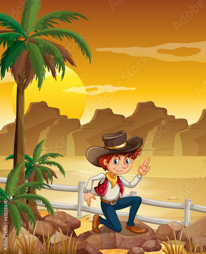A young cowboy at the desert near the rocks