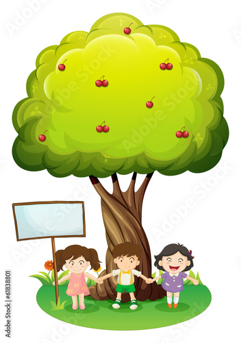 Three kids standing under the tree with an empty signboard