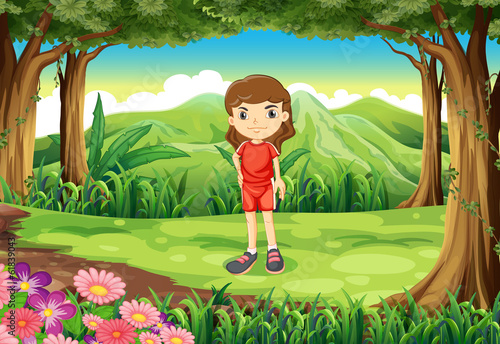 A girl in her red uniform standing at the forest