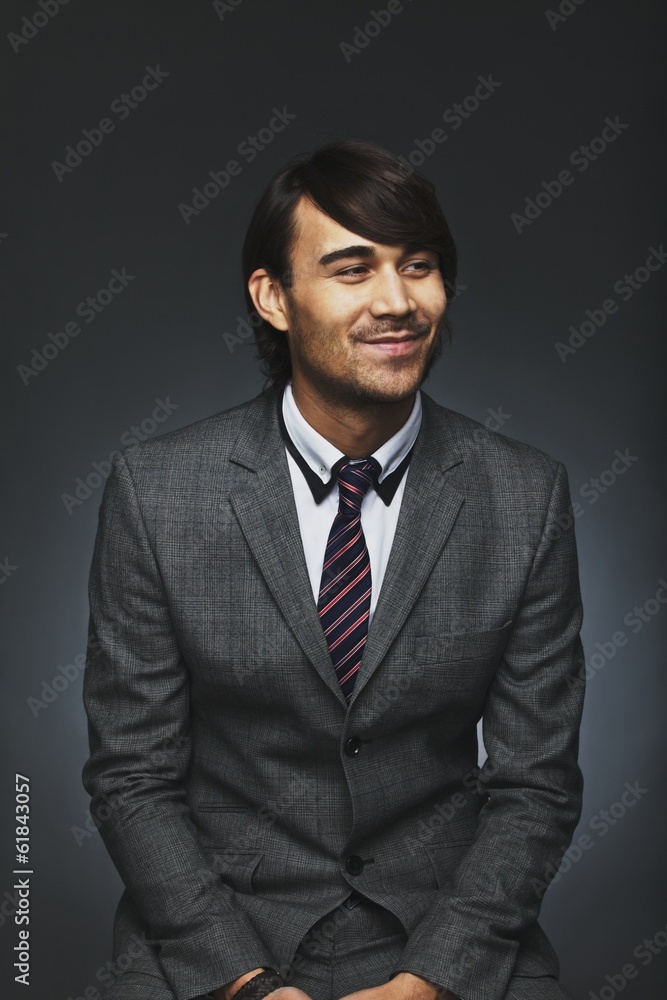 Young businessman looking away smiling Young businessman looking away smiling