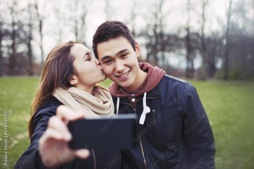 Fototapeta premium Loving teenage couple taking self portrait