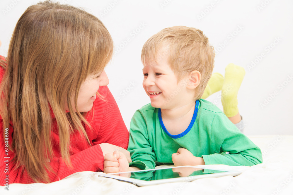 mother and son with touch pad at home mother and son with touch pad at home