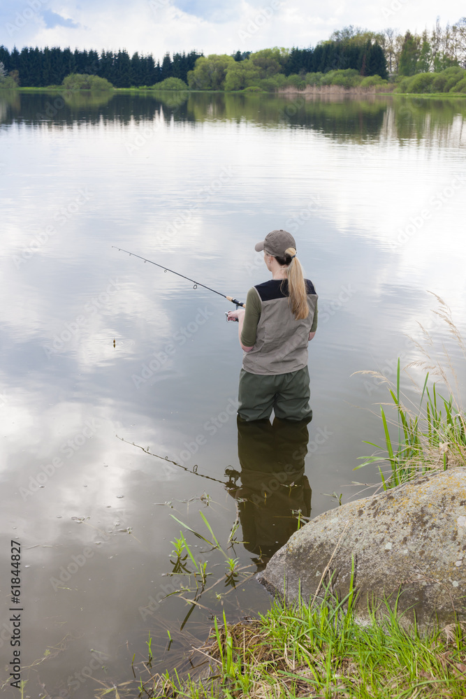 woman fishing in pond in spring woman fishing in pond in spring
