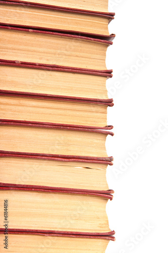 stack of old books with yellowed pages on white background