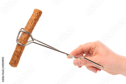 Dutch fast food snack frikandel in frying tongs photo