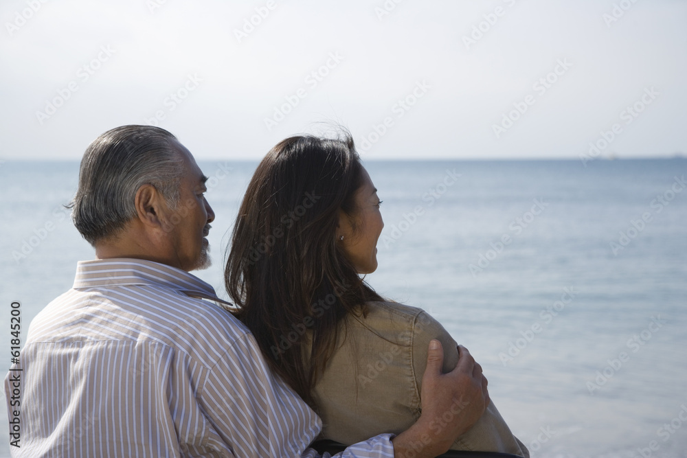 husband and wife looking at sea