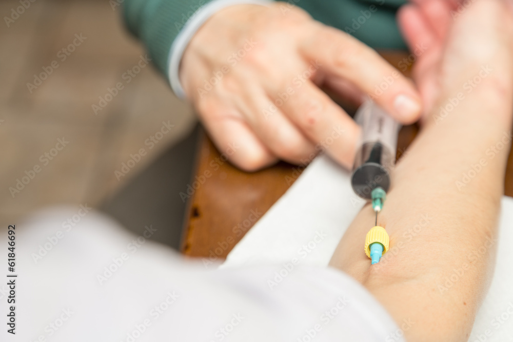 Doctor / Nurse and patient during a iron medicine injection Doctor / Nurse and patient during a iron medicine injection