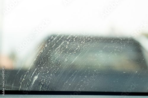 Dirty mirror car windshield with wiper