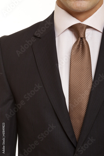 brown suit with brown tie