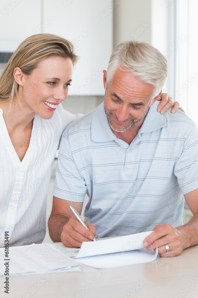 Happy couple working out their finances Happy couple working out their finances