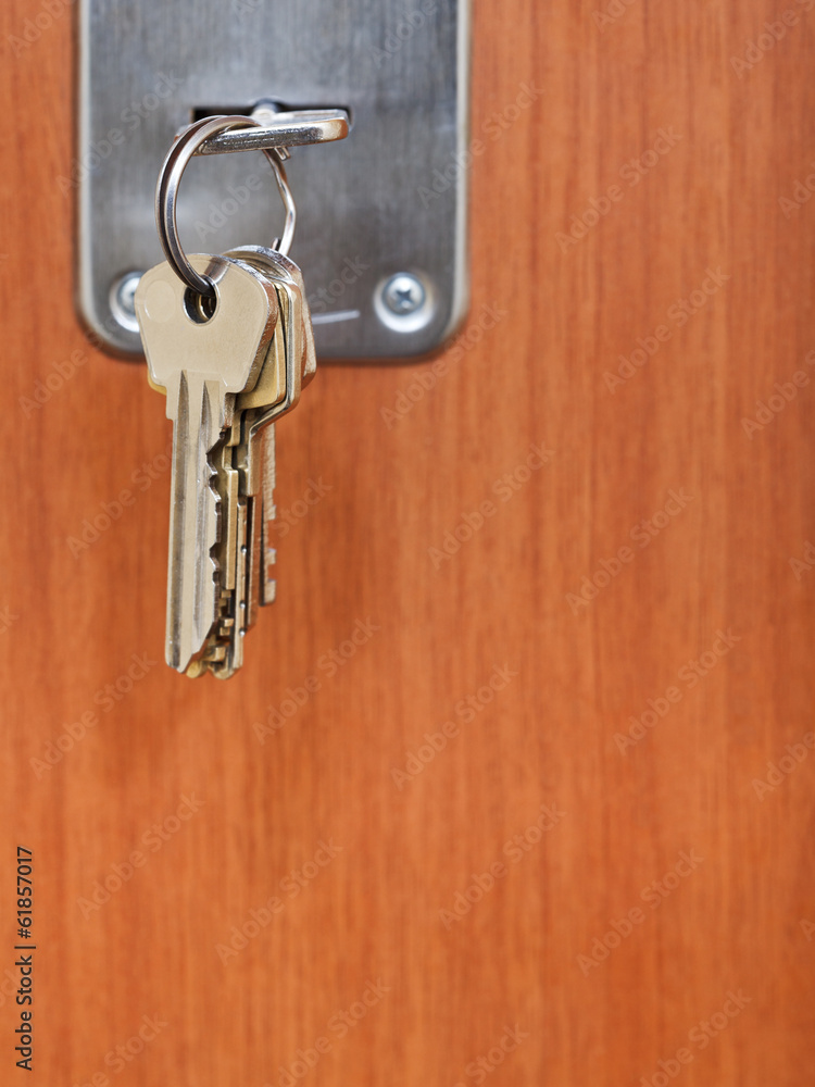 bunch of steel keys in keyhole of door bunch of steel keys in keyhole of door