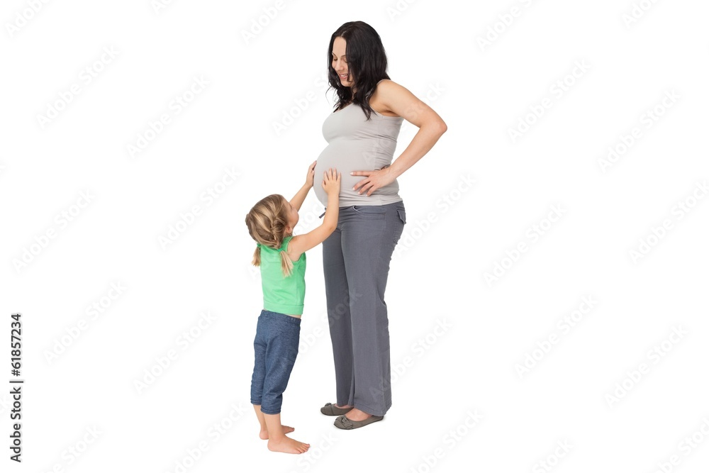 Fototapeta premium Little girl touching her mothers baby bump