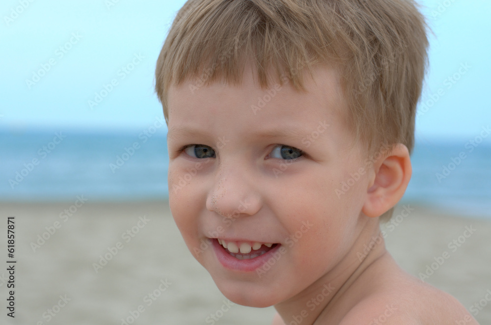 happy little boy on a sand beach happy little boy on a sand beach