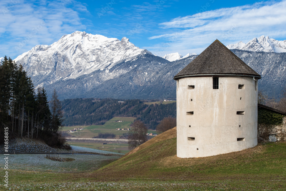 Old tower and part of the Austrian Alps in winter