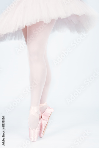 A ballet dancer standing on toes while dancing artistic conversi