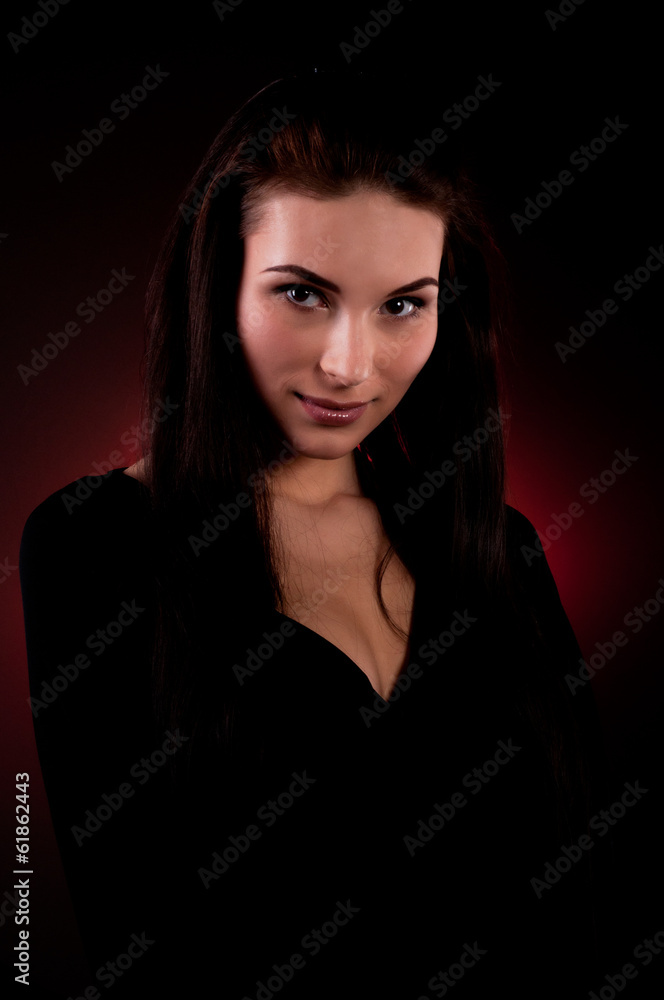Portrait of beautiful young woman on the red background