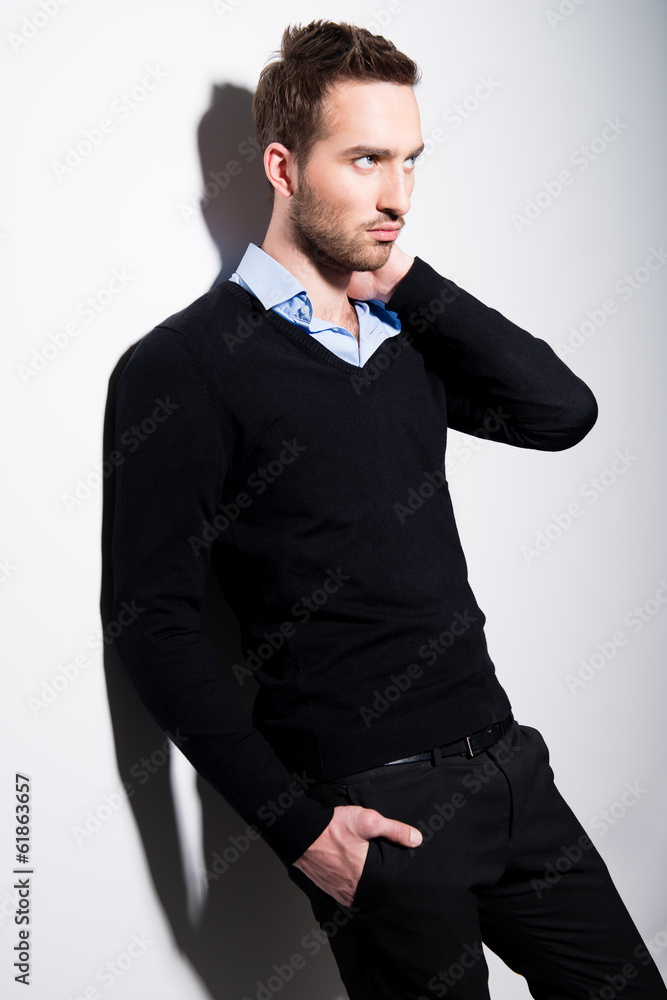 Fashion portrait of young man in black pullover. Fashion portrait of young man in black pullover.