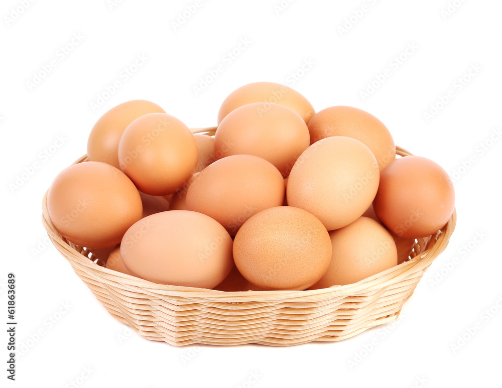Brown eggs in the basket on a white. Brown eggs in the basket on a white.