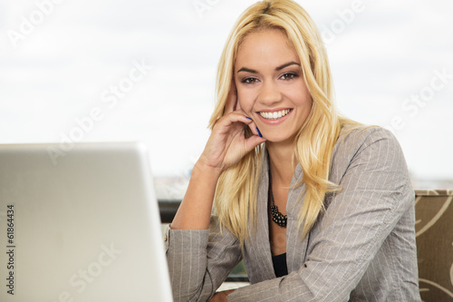 Beautiful young business woman with toothy smile using posing