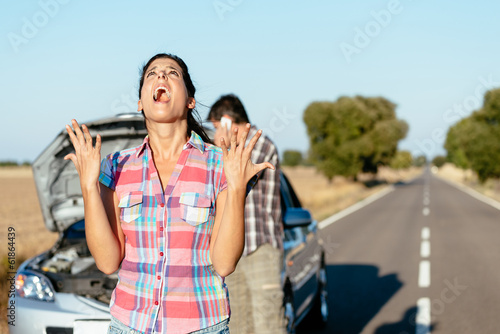 Obraz na plátně Desperate woman suffering car breakdown