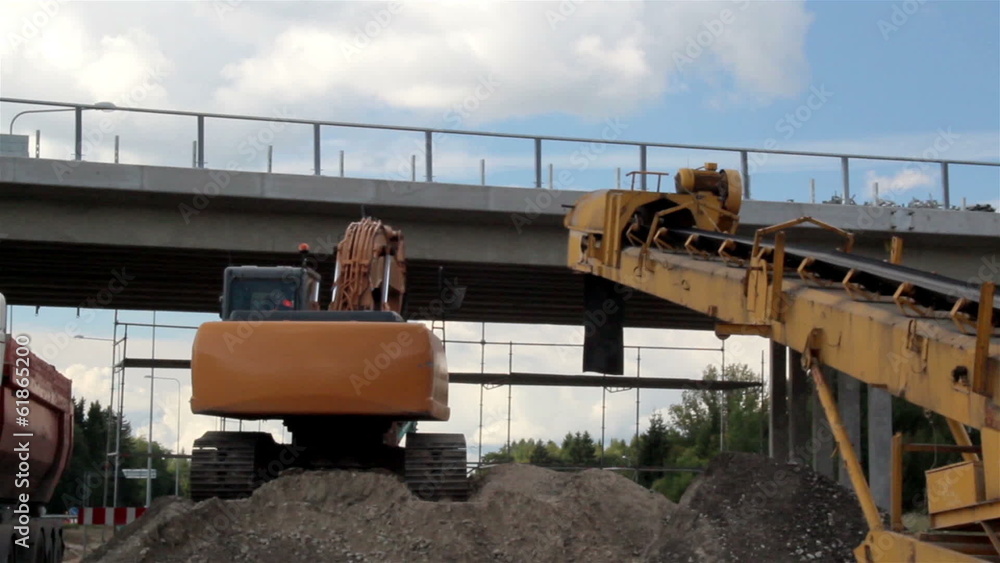 Bulldozer loading soil to the parked truck Bulldozer loading soil to the parked truck