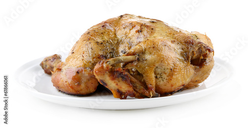 Whole roasted chicken on plate, isolated on white