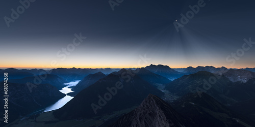 sunrise in mountains of austrian alps with moonligt photo