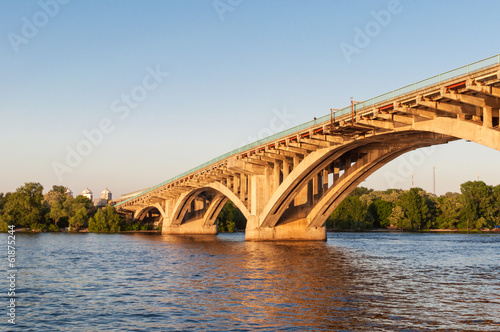 Fototapeta Naklejka Na Ścianę i Meble -  Concrete bridge across a river at sunset