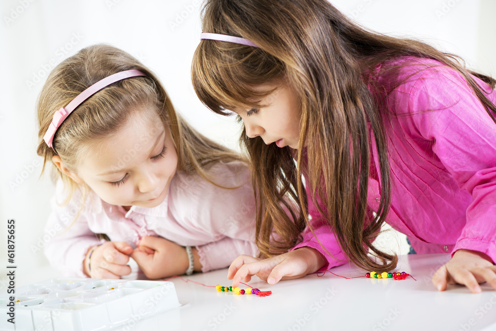 Two cute little girls playing at home. Two cute little girls playing at home.