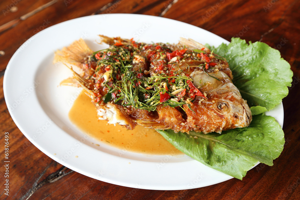 Fried ruby fish topped with sweet,sauer and hot sauce Fried ruby fish topped with sweet,sauer and hot sauce