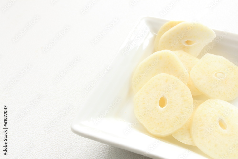 sliced garlic on white dish with copy space sliced garlic on white dish with copy space
