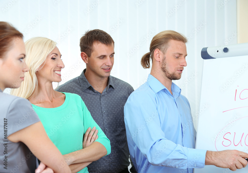 Business team working in office near whiteboard Business team working in office near whiteboard