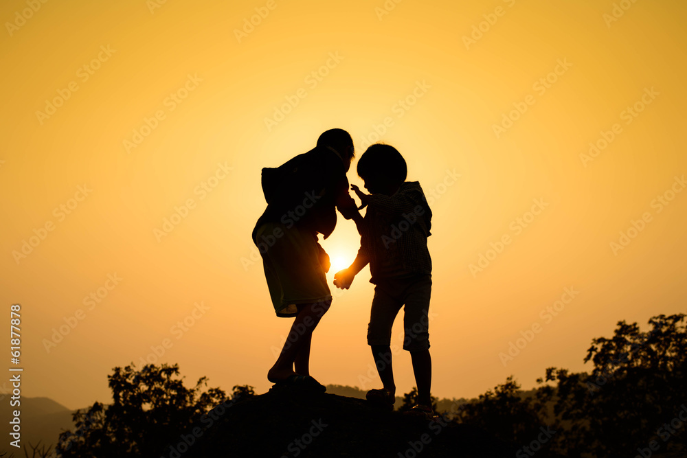 Boy and girl are climbing the hill during sun set. Boy and girl are climbing the hill during sun set.