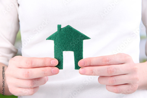 Little paper house in hand close-up