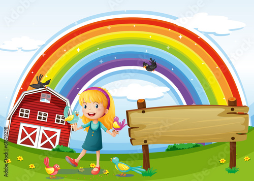 A girl beside the empty signboard with a rainbow in the sky