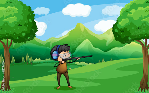 A man with a gun at the forest