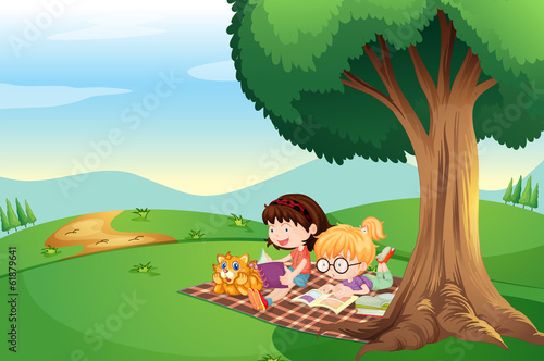 Kids reading under the tree with a cat