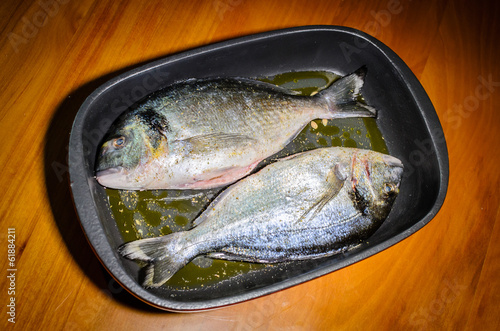 A pair of sea bream ready to be cooked in the oven