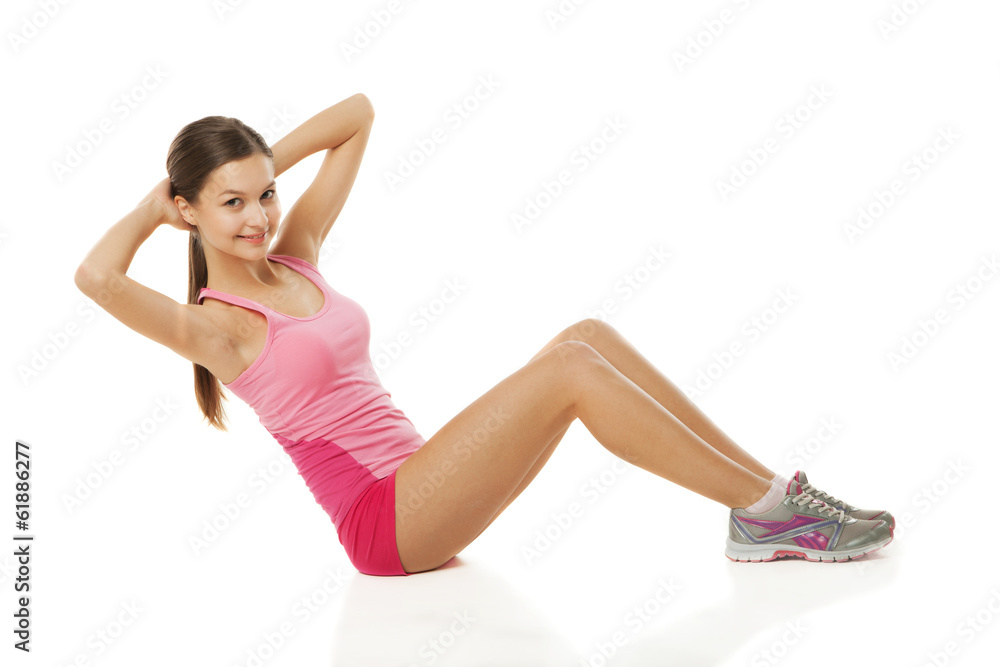 Young sporty woman doing exercises over white Young sporty woman doing exercises over white