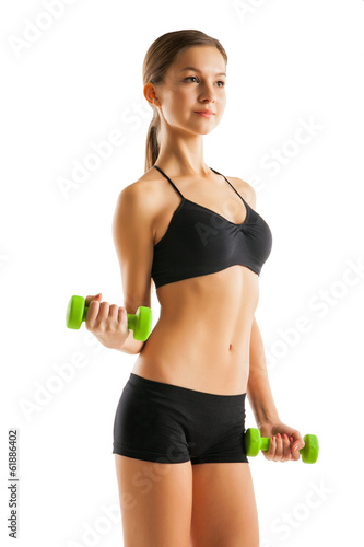 Athletic woman pumping up muscles with dumbbells