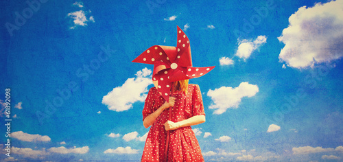 Obraz na plátne Redhead girl with toy wind turbine