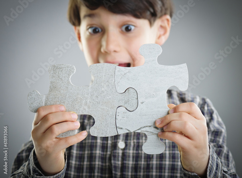 Kids connecting the jigsaw puzzle
