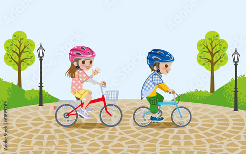 Kids riding bicycle in the park,wore Helmet