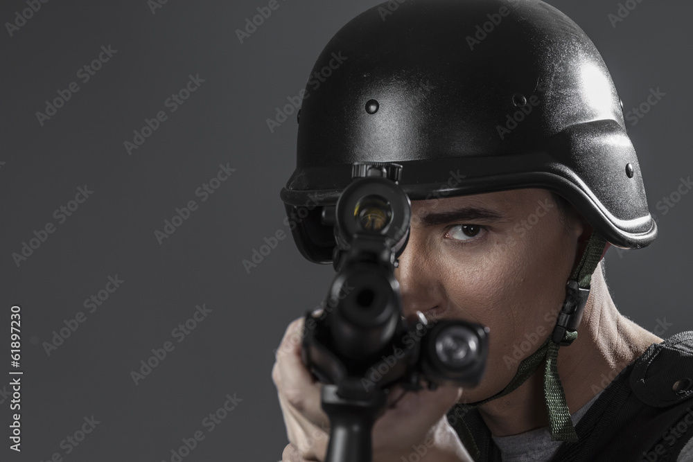 Assault, paintball sport player wearing protective helmet aiming Assault, paintball sport player wearing protective helmet aiming