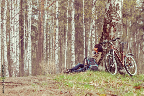 Cyclist rests in a forest