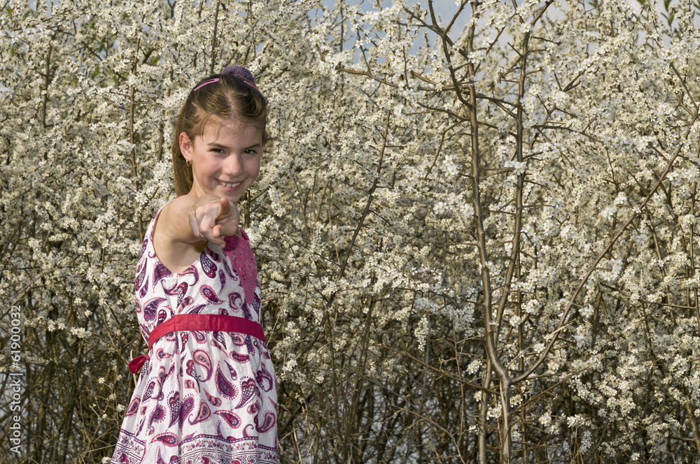 Girl with white flowers pointing to camera Girl with white flowers pointing to camera