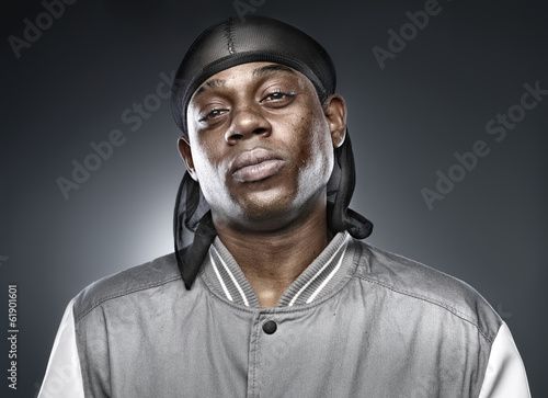 african rapper on grey background with bold lighting